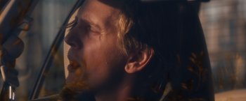 Movie still from “Broken City” (2013), directed by Allen Hughes – A person's ear and face; Close Up shot, Low angle