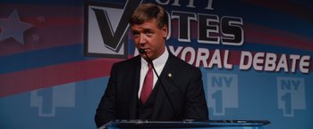 Movie still from “Broken City” (2013), directed by Allen Hughes – A man in a black suit and a red tie; Medium shot, High angle