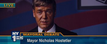 Movie still from “Broken City” (2013), directed by Allen Hughes – A man's face in front of a tv screen; Close Up shot, High angle