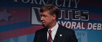 Movie still from “Broken City” (2013), directed by Allen Hughes – A person wearing a suit and tie; Close Up shot, Low angle