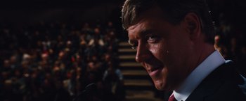 Movie still from “Broken City” (2013), directed by Allen Hughes – A person speaking at a microphone; Close Up shot, Low angle