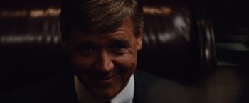 Movie still from “Broken City” (2013), directed by Allen Hughes – A person wearing a suit and tie; Close Up shot, Over the shoulder angle