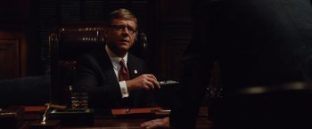 Movie still from “Broken City” (2013), directed by Allen Hughes – A man sitting at a table in front of another man; Close Up shot, Over the shoulder angle