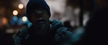 Movie still from “Broken City” (2013), directed by Allen Hughes – A person wearing a jacket and a hat; Close Up shot, Over the shoulder angle