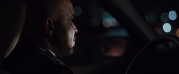 Movie still from “Broken City” (2013), directed by Allen Hughes – A person in a car at night; Close Up shot, Over the shoulder angle