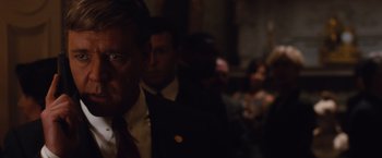 Movie still from “Broken City” (2013), directed by Allen Hughes – A group of people standing in a dark room; Close Up shot, Over the shoulder angle