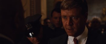 Movie still from “Broken City” (2013), directed by Allen Hughes – A man in a suit and tie; Close Up shot, Over the shoulder angle