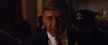 Movie still from “Broken City” (2013), directed by Allen Hughes – A person wearing a suit and tie; Close Up shot, Over the shoulder angle