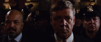 Movie still from “Broken City” (2013), directed by Allen Hughes – A person wearing a suit and tie; Close Up shot, Over the shoulder angle