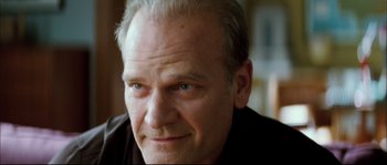 Movie still from “Broken Embraces” (2009), directed by Pedro Almodóvar – A person with a beard; Close Up shot, Over the shoulder angle