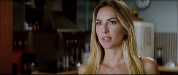 Movie still from “Broken Embraces” (2009), directed by Pedro Almodóvar – A woman with long blonde hair looking at the camera; Close Up shot, Over the shoulder angle