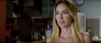 Movie still from “Broken Embraces” (2009), directed by Pedro Almodóvar – A beautiful woman with long blonde hair looking at the camera; Close Up shot, Over the shoulder angle