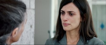 Movie still from “Broken Embraces” (2009), directed by Pedro Almodóvar – A person with long black hair; Close Up shot, Over the shoulder angle