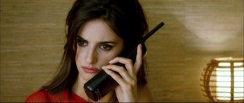Movie still from “Broken Embraces” (2009), directed by Pedro Almodóvar – A beautiful woman holding a cell phone to her ear; Close Up shot, Low angle