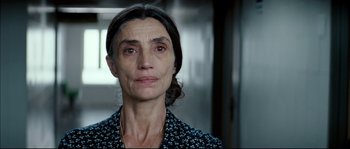 Movie still from “Broken Embraces” (2009), directed by Pedro Almodóvar – A person wearing a black and white shirt; Close Up shot, Over the shoulder angle