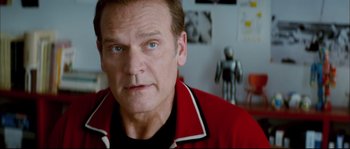 Movie still from “Broken Embraces” (2009), directed by Pedro Almodóvar – A person wearing a red jacket; Close Up shot, Over the shoulder angle