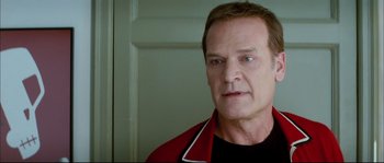 Movie still from “Broken Embraces” (2009), directed by Pedro Almodóvar – A person wearing a black t - shirt; Close Up shot, Low angle