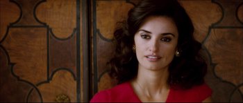 Movie still from “Broken Embraces” (2009), directed by Pedro Almodóvar – A woman in a red shirt is posing for a picture; Close Up shot, Over the shoulder angle