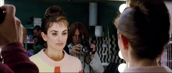 Movie still from “Broken Embraces” (2009), directed by Pedro Almodóvar – A man taking a picture of a woman in front of a mirror; Close Up shot, Over the shoulder angle