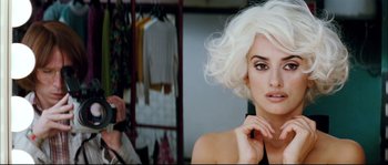 Movie still from “Broken Embraces” (2009), directed by Pedro Almodóvar – A woman in a white wig taking a picture of herself; Close Up shot, Over the shoulder angle