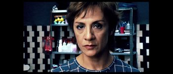 Movie still from “Broken Embraces” (2009), directed by Pedro Almodóvar – A person with short brown hair; Close Up shot, Low angle