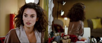 Movie still from “Broken Embraces” (2009), directed by Pedro Almodóvar – A person sitting in front of a mirror; Close Up shot, Over the shoulder angle