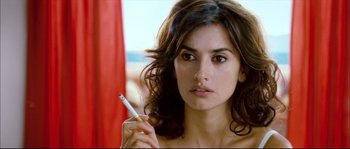 Movie still from “Broken Embraces” (2009), directed by Pedro Almodóvar – A beautiful woman holding a cigarette in her mouth; Close Up shot, Over the shoulder angle