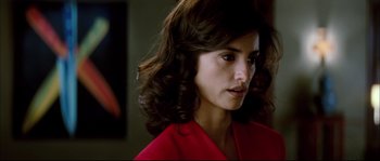 Movie still from “Broken Embraces” (2009), directed by Pedro Almodóvar – A person wearing a red shirt; Close Up shot, Over the shoulder angle
