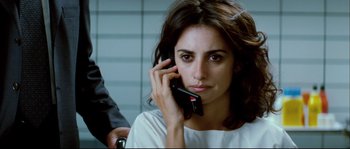 Movie still from “Broken Embraces” (2009), directed by Pedro Almodóvar – A woman holding a cell phone to her ear; Close Up shot, Over the shoulder angle