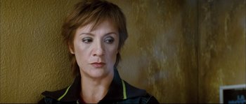 Movie still from “Broken Embraces” (2009), directed by Pedro Almodóvar – A person with short hair; Close Up shot, Over the shoulder angle