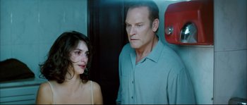 Movie still from “Broken Embraces” (2009), directed by Pedro Almodóvar – A man and a woman standing next to each other in a room; Close Up shot, Over the shoulder angle