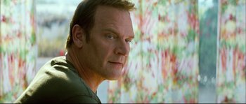 Movie still from “Broken Embraces” (2009), directed by Pedro Almodóvar – A person wearing a green shirt; Close Up shot, Low angle