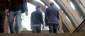 Movie still from “Broken Embraces” (2009), directed by Pedro Almodóvar – Two men walking up stairs in a building; Wide shot, Over the shoulder angle