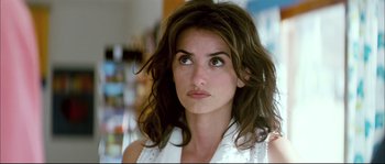 Movie still from “Broken Embraces” (2009), directed by Pedro Almodóvar – A person wearing a white shirt; Close Up shot, Over the shoulder angle