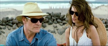 Movie still from “Broken Embraces” (2009), directed by Pedro Almodóvar – A man and a woman sitting on the beach; Close Up shot, Over the shoulder angle