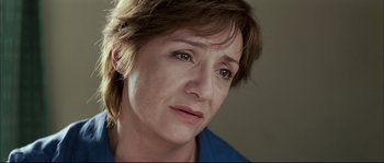 Movie still from “Broken Embraces” (2009), directed by Pedro Almodóvar – A person with short brown hair; Close Up shot, Low angle