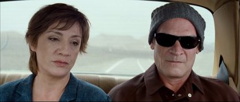Movie still from “Broken Embraces” (2009), directed by Pedro Almodóvar – A man and a woman sitting in the back of a car; Close Up shot, Over the shoulder angle