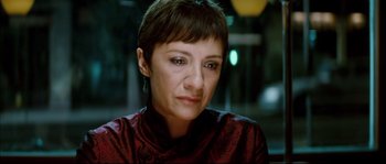 Movie still from “Broken Embraces” (2009), directed by Pedro Almodóvar – A person with short brown hair; Close Up shot, Over the shoulder angle