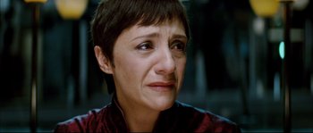 Movie still from “Broken Embraces” (2009), directed by Pedro Almodóvar – A person with short brown hair; Close Up shot, High angle