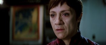 Movie still from “Broken Embraces” (2009), directed by Pedro Almodóvar – A person with short brown hair; Close Up shot, Low angle
