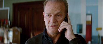 Movie still from “Broken Embraces” (2009), directed by Pedro Almodóvar – A person talking on a cell phone; Close Up shot, Low angle