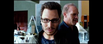 Movie still from “Broken Embraces” (2009), directed by Pedro Almodóvar – A person wearing glasses and a jacket; Close Up shot, Low angle