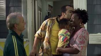 Movie still from “Broken Flowers” (2005), directed by Jim Jarmusch – A group of people standing next to each other in a room; Medium shot, Over the shoulder angle