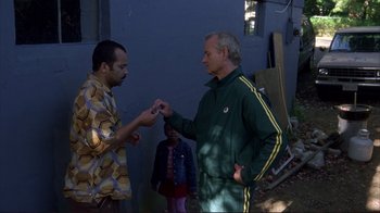 Movie still from “Broken Flowers” (2005), directed by Jim Jarmusch – Two men standing next to each other in front of a building; Medium shot, Over the shoulder angle