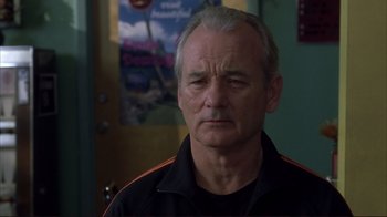 Movie still from “Broken Flowers” (2005), directed by Jim Jarmusch – A man in a black shirt is looking at the camera; Close Up shot, Over the shoulder angle