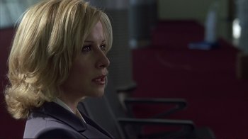 Movie still from “Broken Flowers” (2005), directed by Jim Jarmusch – A woman with blonde hair sitting in front of a chair; Close Up shot, Over the shoulder angle