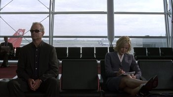 Movie still from “Broken Flowers” (2005), directed by Jim Jarmusch – A man and a woman sitting in a waiting area; Wide shot, Low angle