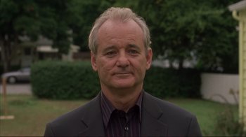 Movie still from “Broken Flowers” (2005), directed by Jim Jarmusch – A man in a black suit and striped shirt; Close Up shot, Low angle
