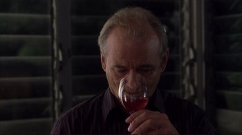 Movie still from “Broken Flowers” (2005), directed by Jim Jarmusch – An older man drinking a glass of red wine; Close Up shot, Low angle