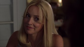 Movie still from “Broken Flowers” (2005), directed by Jim Jarmusch – A woman with long blonde hair sitting in a room; Close Up shot, Over the shoulder angle